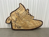 an image of a wooden shoe with an image of a nike swoosh on it