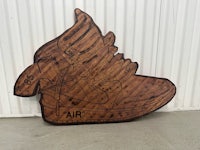 a wood carving of a pair of nike air force 1's